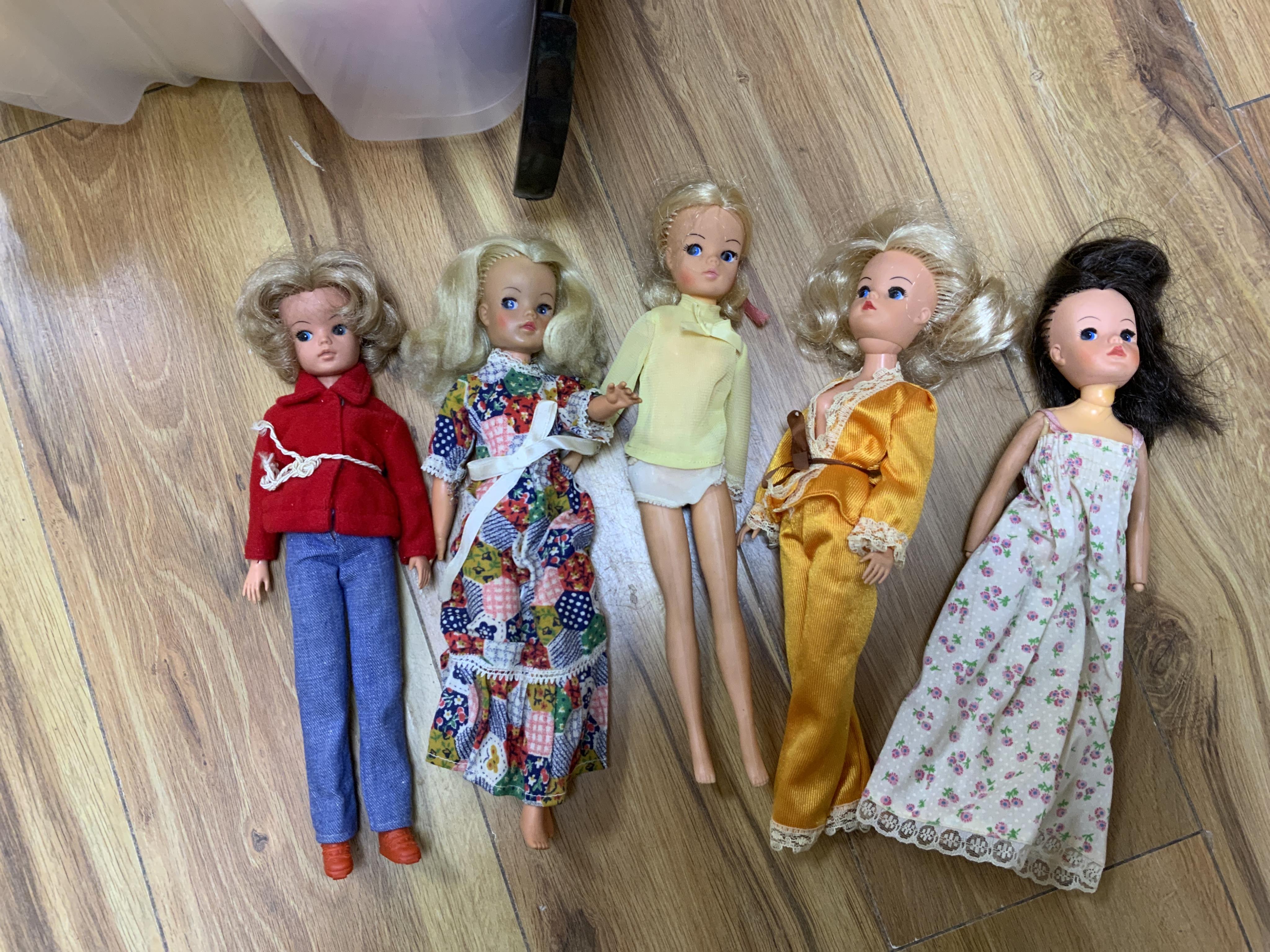 A collection of 1960s-80s Sindy dolls and accessories, including; five dolls, an early plywood and hardboard caravan, a large selection of clothing and accessories, furniture, house fittings, including a shower, wardrobe